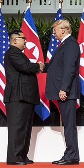 Donald Trump and Kim Jong Un shake hands at the Singapore Summit, 2018. By Dan Scavino Jr. [Public domain], via Wikimedia Commons.